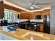 Charming kitchen with wooden cabinets, granite countertops, and an eat-in bar area at 100 Bluff View Dr # 114C, Belleair Bluffs, FL 33770