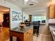 Open-concept kitchen featuring a functional island, granite counters, and bar seating at 100 Bluff View Dr # 114C, Belleair Bluffs, FL 33770