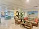 Inviting living room features tile flooring, and comfortable seating arrangements with views of the community area at 100 Bluff View Dr # 114C, Belleair Bluffs, FL 33770