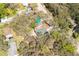 An aerial perspective of two homes nestled within a verdant area, showcasing the houses and their environmental context at 10219 Huntley St, New Port Richey, FL 34654