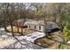 Aerial view of the property, featuring modern design, landscaping, and paved driveway at 10219 Huntley St, New Port Richey, FL 34654