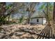 View of the backyard and neighboring properties, surrounded by mature trees at 10219 Huntley St, New Port Richey, FL 34654