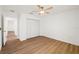 Neutral bedroom with hardwood floors, a ceiling fan, and a closet for storage solutions at 10219 Huntley St, New Port Richey, FL 34654