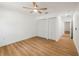 Neutral bedroom with hardwood floors, a ceiling fan, and a closet for storage solutions at 10219 Huntley St, New Port Richey, FL 34654