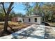 Exterior view of home featuring modern design, landscaping, and paved driveway at 10219 Huntley St, New Port Richey, FL 34654