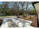 Exterior view of property featuring landscaping, mature trees, and driveway at 10219 Huntley St, New Port Richey, FL 34654