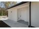 Exterior entrance featuring white siding, concrete walkway, and modern design at 10219 Huntley St, New Port Richey, FL 34654