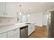 Open-concept kitchen with white cabinetry, stainless steel appliances, and a view into the living area at 10219 Huntley St, New Port Richey, FL 34654