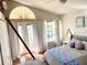 Charming bedroom with patterned bedding and curtains, bright natural light, and welcoming decor at 1050 Starkey Rd # 106, Largo, FL 33771