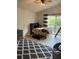 Cozy bedroom featuring a ceiling fan, patterned rug, and a comfortable bed near a window at 1050 Starkey Rd # 106, Largo, FL 33771