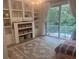 Serene bedroom with custom shelving, a comfortable bed, and access to the balcony at 1050 Starkey Rd # 106, Largo, FL 33771
