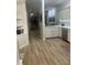 Bright kitchen featuring white cabinets, stainless steel appliances, and wood flooring at 1050 Starkey Rd # 106, Largo, FL 33771