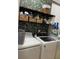 Well-organized laundry room with modern appliances, shelving, and storage baskets, ideal for efficiency at 1050 Starkey Rd # 106, Largo, FL 33771