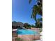 Inviting outdoor pool with brick patio and lush greenery, perfect for relaxation and recreation at 1050 Starkey Rd # 106, Largo, FL 33771