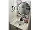 Stylish half bath featuring a vessel sink, modern fixtures, and designer wallpaper at 1050 Starkey Rd # 106, Largo, FL 33771