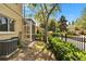 Backyard with a screened patio, lush landscaping, and a black metal fence at 10606 Shady Falls Ct, Riverview, FL 33578