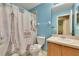 Charming bathroom with Eiffel Tower-themed shower curtain and blue walls at 10606 Shady Falls Ct, Riverview, FL 33578
