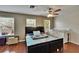 Bright bedroom with wood floors, ceiling fan, natural light, and a crib, perfect for Gathering living at 10606 Shady Falls Ct, Riverview, FL 33578