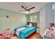 Cozy bedroom with green walls, light-colored accents, and a comfortable bed at 10606 Shady Falls Ct, Riverview, FL 33578