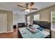 Bright bedroom with hardwood floors, a ceiling fan, and ample natural light at 10606 Shady Falls Ct, Riverview, FL 33578