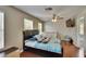 Inviting bedroom offering natural light, ceiling fan, wood floors, and a cozy crib area at 10606 Shady Falls Ct, Riverview, FL 33578