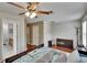 Bright bedroom with a ceiling fan, walk-in closet, and an ensuite bathroom at 10606 Shady Falls Ct, Riverview, FL 33578