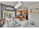 Elegant dining area featuring a glass table, modern chandelier, and view to the kitchen at 10606 Shady Falls Ct, Riverview, FL 33578