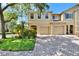 Charming two-story home featuring a two-car garage, landscaped yard, and brick-paved driveway at 10606 Shady Falls Ct, Riverview, FL 33578