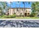 Inviting two-story home surrounded by lush greenery and mature trees, offering a serene curb appeal at 10606 Shady Falls Ct, Riverview, FL 33578