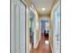Hallway features wood floors and multiple bedrooms and bathrooms at 10606 Shady Falls Ct, Riverview, FL 33578