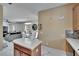 Bright kitchen features an island, modern appliances, and is open to the dining and living areas at 10606 Shady Falls Ct, Riverview, FL 33578