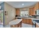 Well-lit kitchen boasting a central island, ample counter space, and mosaic tile backsplash at 10606 Shady Falls Ct, Riverview, FL 33578