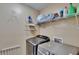 Functional laundry area equipped with modern machines, shelving, and essential laundry amenities at 10606 Shady Falls Ct, Riverview, FL 33578