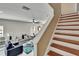 View of the living room with staircase featuring a ceiling fan and lots of light at 10606 Shady Falls Ct, Riverview, FL 33578