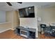 Bright living room with fireplace, television, and desk with wood floors at 10606 Shady Falls Ct, Riverview, FL 33578