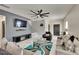 Modern living room with a large TV, stylish decor, and comfortable seating arrangement at 10606 Shady Falls Ct, Riverview, FL 33578