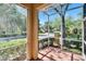 View of the street from the screened in patio with lovely landscaping and fenced yard at 10606 Shady Falls Ct, Riverview, FL 33578