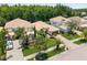 An aerial view shows the house with lush green landscaping, a paved driveway, and a brown tile roof at 10880 Cory Lake Dr, Tampa, FL 33647