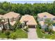 An aerial view of the property shows mature trees, lush landscaping and a brown-tiled roof at 10880 Cory Lake Dr, Tampa, FL 33647