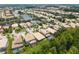 Beautiful aerial view of a luxury home community surrounding a lake with lush landscaping and private pools at 10880 Cory Lake Dr, Tampa, FL 33647