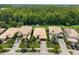 An aerial view showcases the home's landscaping, tile roof, and neighborhood in a wooded area at 10880 Cory Lake Dr, Tampa, FL 33647