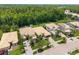 Aerial view showcases the community with lush landscaping, multiple residences, and beautiful wooded backdrop at 10880 Cory Lake Dr, Tampa, FL 33647