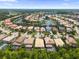 A sprawling residential area featuring numerous houses nestled around a scenic lake and surrounded by lush greenery at 10880 Cory Lake Dr, Tampa, FL 33647