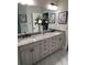 Elegant bathroom featuring double sinks, granite countertops, and neutral decor at 10880 Cory Lake Dr, Tampa, FL 33647