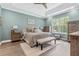 Tranquil bedroom boasts a tray ceiling, soft colors, and ample natural light at 10880 Cory Lake Dr, Tampa, FL 33647
