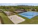 Overhead view of multiple community sport courts with lush green surroundings, promoting an active lifestyle at 10880 Cory Lake Dr, Tampa, FL 33647