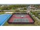 Aerial view of tennis, volleyball and pickleball courts in a well-maintained community at 10880 Cory Lake Dr, Tampa, FL 33647