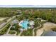 Aerial view of community pool with play area, splash pad, and mature landscaping at 10880 Cory Lake Dr, Tampa, FL 33647