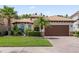Charming single-story home featuring a tile roof, brick driveway, and lush tropical landscaping at 10880 Cory Lake Dr, Tampa, FL 33647