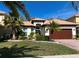 Charming single-story home featuring a well-manicured lawn, mature landscaping and a welcoming front entrance at 10880 Cory Lake Dr, Tampa, FL 33647